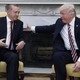 Trump pats Erdoğan on the back during a meeting in the Oval Office.