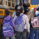 Students board a bus. 