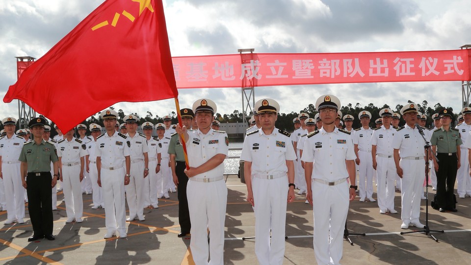 People's Liberation Army soldiers stand guard at a military port in Zhanjiang, Guangdong province, on July 11.