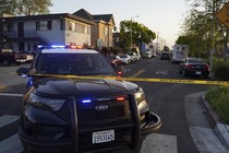 A photo of a police car near yellow crime scene tape