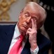 President Trump with his fingers rubbing his eye