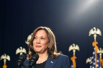 A photo of Kamala Harris standing at a mic