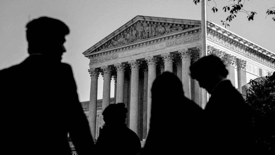 Three shadowy figures in front of the Supreme Court