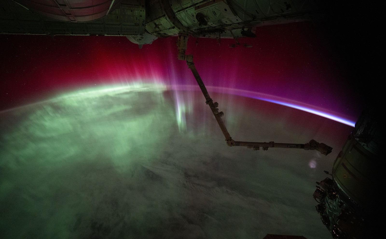 A green and pink aurora seen from space