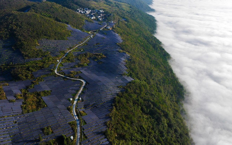 An aerial view of solar panels installed on a mountainside