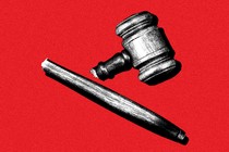 A broken gavel on a red background