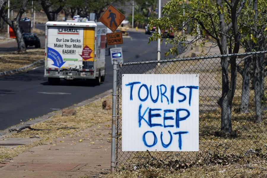 A "Tourist Keep Out" sign is displayed in a neighborhood.