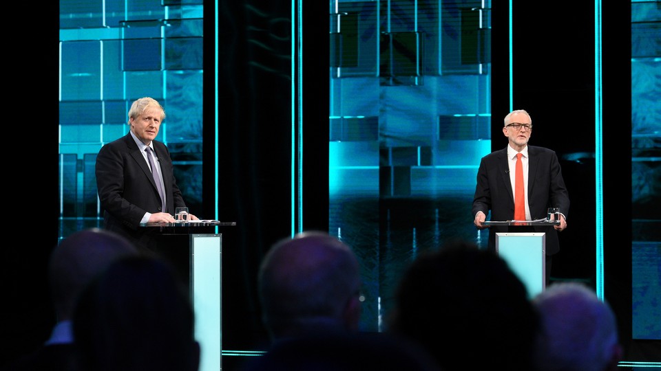 Boris Johnson and Jeremy Corbyn stand on a TV debate stage.