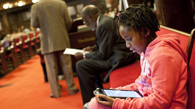 A young person reads on an e-reader.