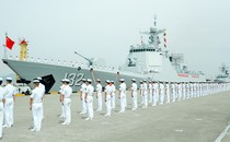 Members of the Chinese navy stand on the deck of a naval destroyer.
