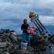 A woman holds a stuffed rabbit toy after it was found at her destroyed home where she said she had lost her three children, in Palu, Central Sulawesi, Indonesia.