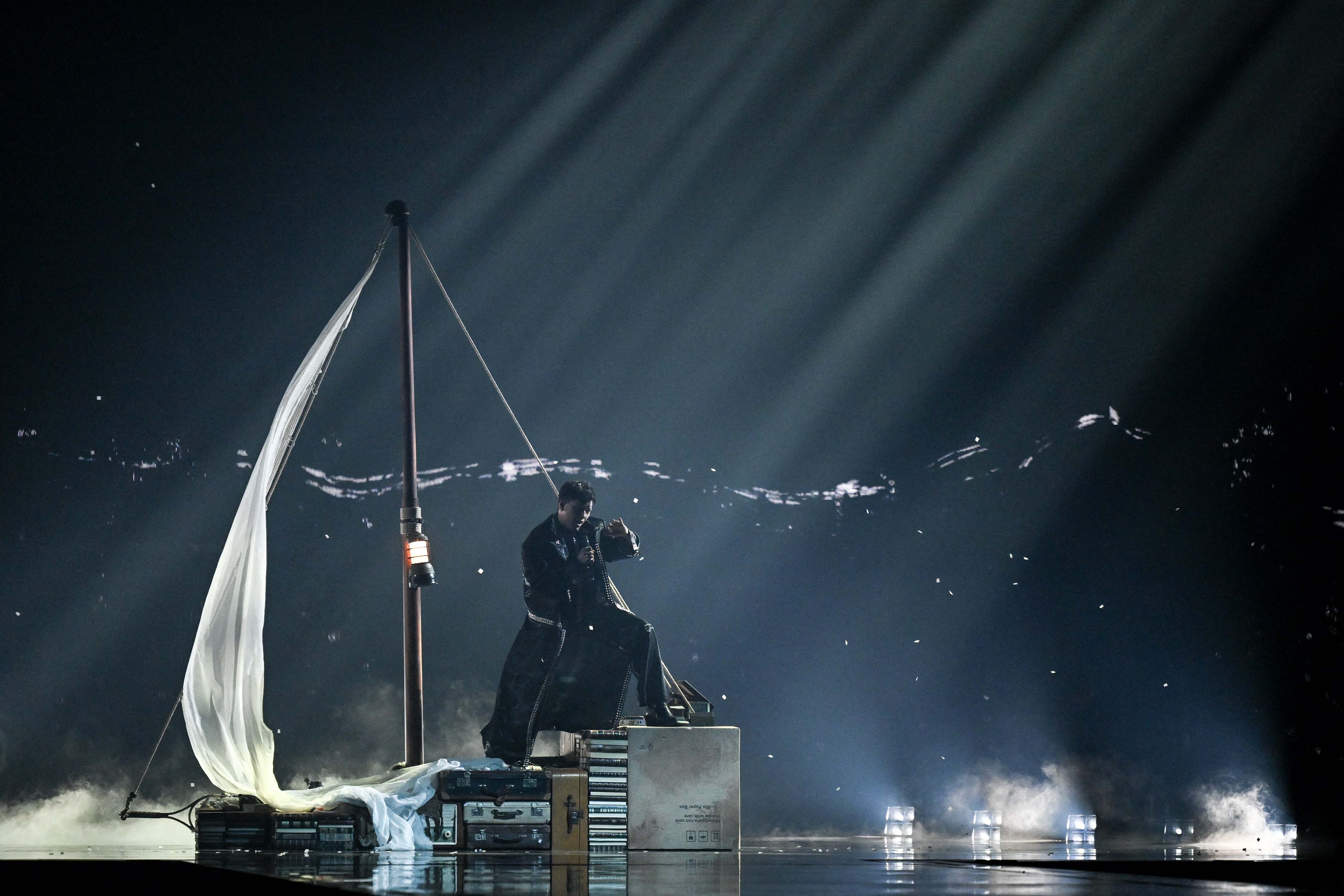 Performers sing as they stood on the decorations of sailboats made of boxes and books.