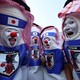 A group of four soccer fans wear makeup and costumes to cheer for Team Japan.