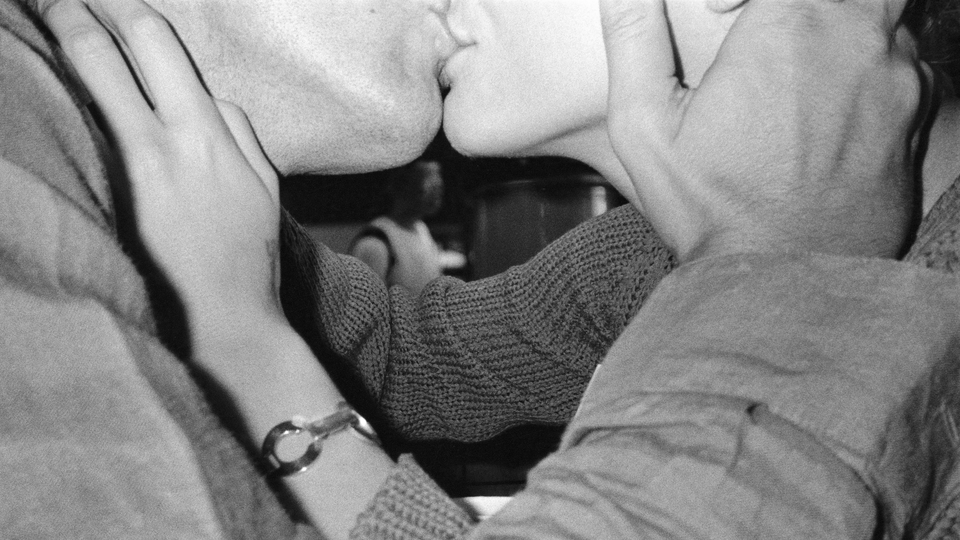 a black-and-white photo of two people kissing