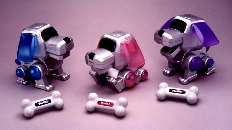 A photograph of three Poo-Chi devices and their little dog bones