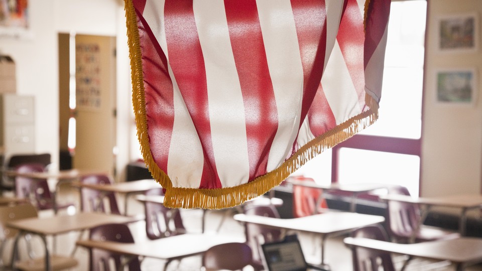 An American flag hangs above a classroom