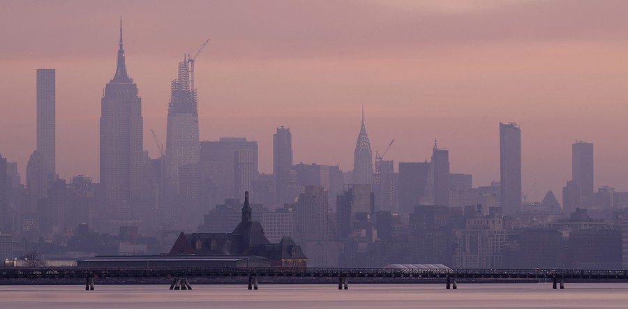A hazy sky at sunrise, above the New York City skyline