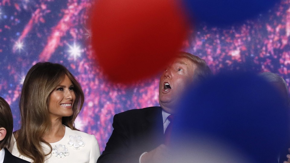 Melania Trump and her husband Donald celebrate with family as balloons fall at the conclusion of the Republican National Convention in Cleveland in July.