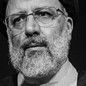 Black and white close-up of Ebrahim Raisi with a serious expression.