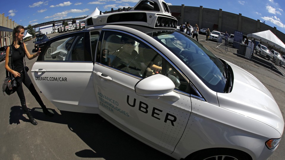 A journalist gets in a self driving Uber for a ride during a media preview at Uber's Advanced Technologies Center in Pittsburgh Monday, Sept. 12, 2016.