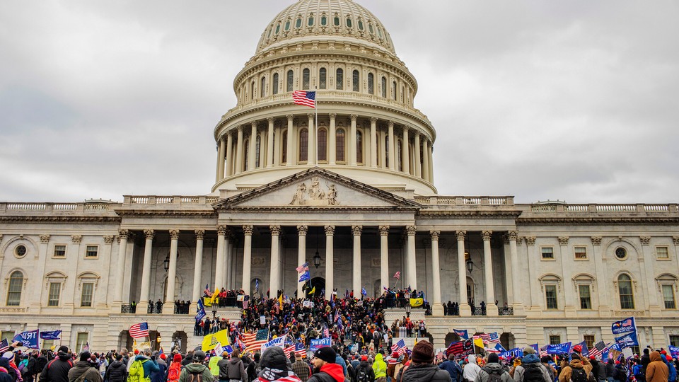 A color photograph of Trump supporters storming the U.S. Capitol Building on January 6, 2021.