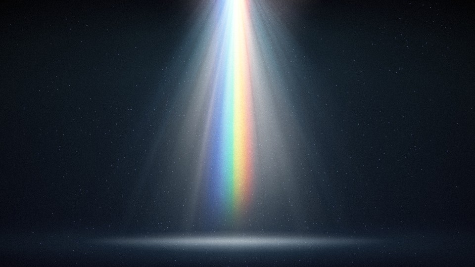 A rainbow-colored light shining down into a dark space