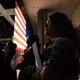 U.S.-citizenship candidates look at a video presentation as they wait to take the oath of citizenship at a naturalization ceremony.