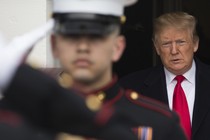 Donald Trump stands behind US Marines who are saluting