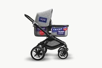 A baby stroller with Trump bumper stickers on it