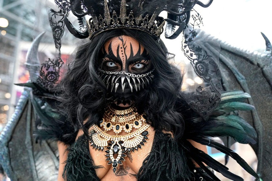 A person poses while wearing an elaborate costume.