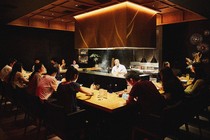 An image of diners sitting inside a full restaurant.