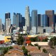 Single-family homes sit in front of the Los Angeles skyline