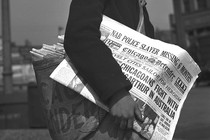 Boy selling chicago defender newspaper in 1942