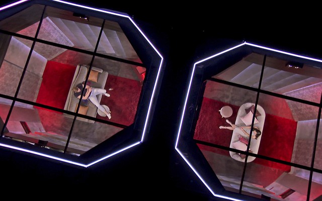 An image from "Love is Blind": A man and woman sit in opposite pods