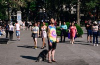 a person with a dog in Washington Square Park in May of 2021