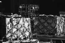 Boxes of military equipment arriving in an airport platform