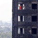 Members of the emergency services work inside the charred remains of the Grenfell Tower block on June 17, 2017.