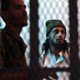 A suspected al-Qaeda militant stands behind bars. 