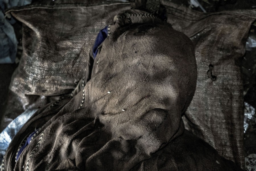 A shawl lies over a dead person's face.