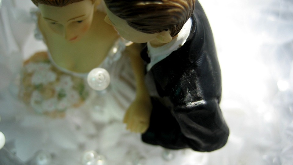 Bride and groom wedding-cake toppers.
