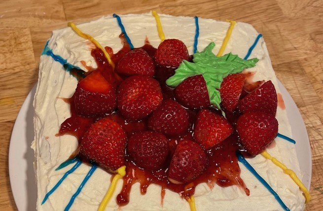 A cake covered with strawberries and jam, made to look like the album art for Animal Collective's Strawberry Jam.
