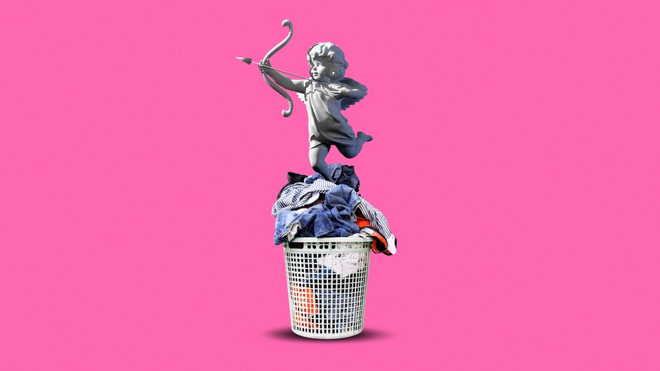 A statue of cupid on top of a basket of laundry