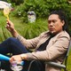 Jon Chu sitting in a lawn chair with bubbles