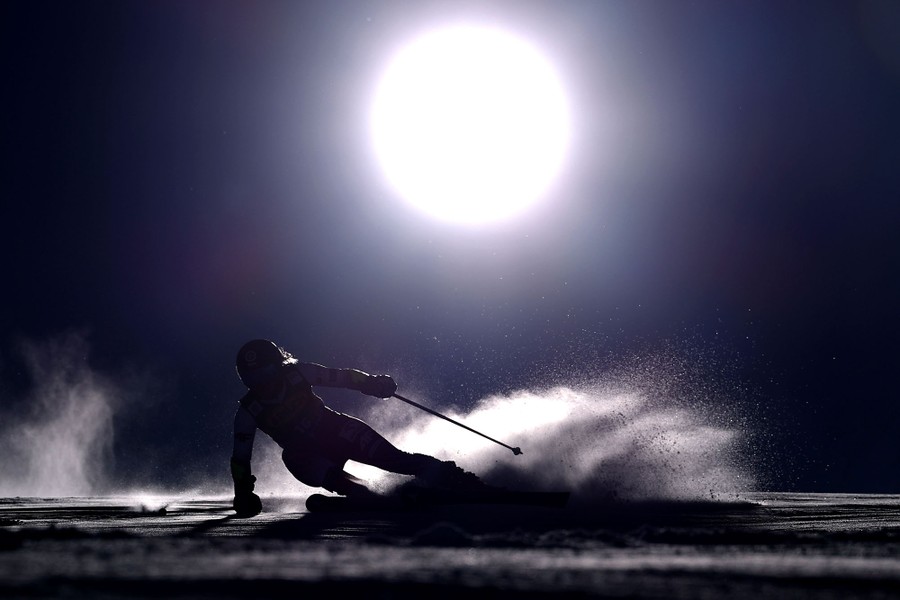 A person leans into a turn on a ski run during a race.