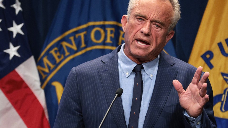 RFK Jr. speaks at a podium.
