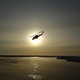 A helicopter flies over Arctic ice toward the Applied Physics Laboratory Ice Station.