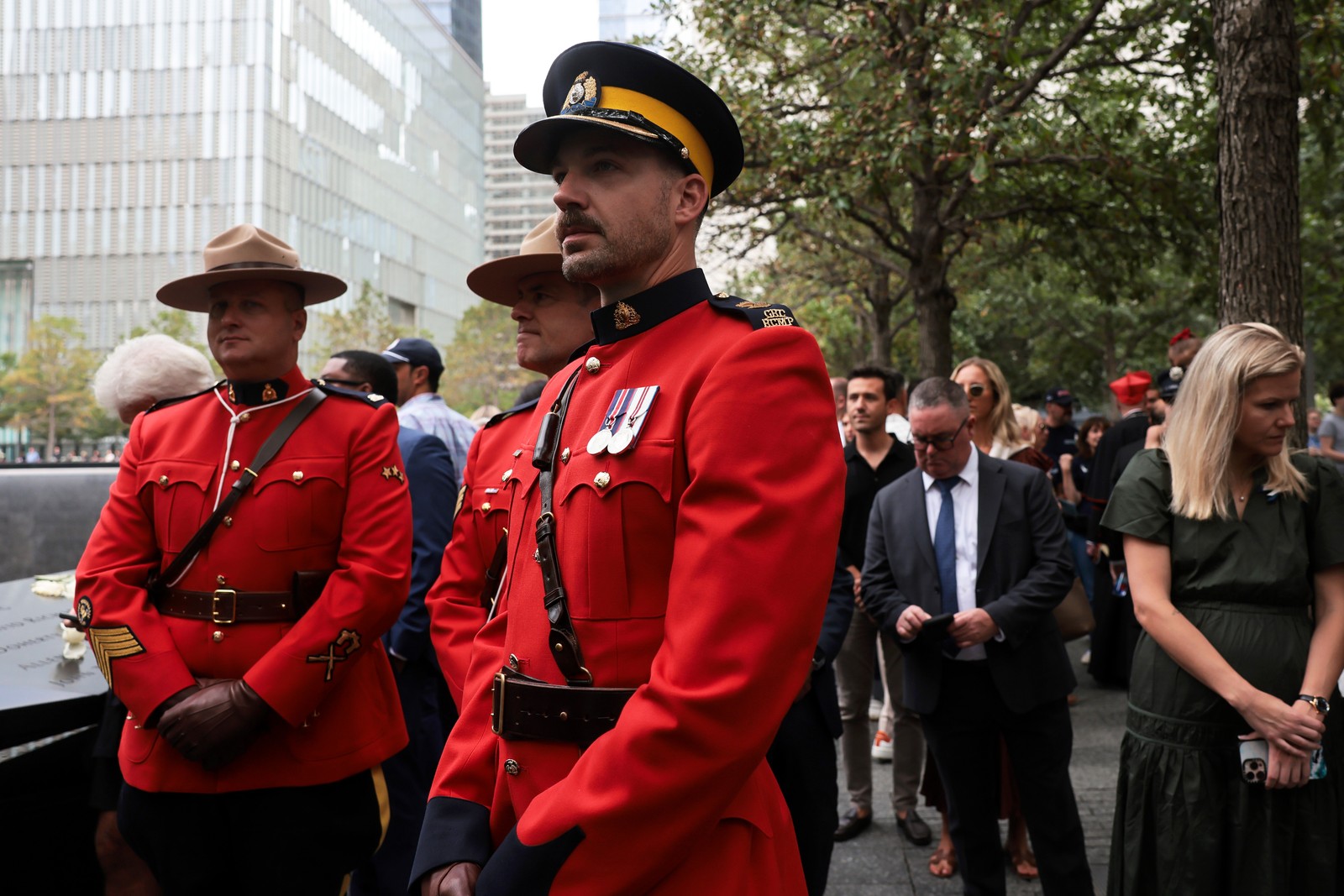 Three members of the Royal Canadian Mounted Police look on during a memorial ceremony in New York.