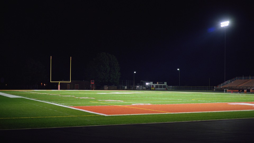 An empty football field at night.