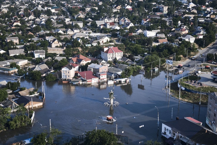 An aerial view of a flooded city square and neighborhood