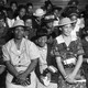 A black-and-white image of Black women sitting in church pews